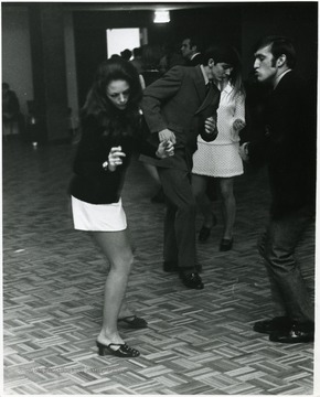 The woman in the white shirt is Playboy Magazine Playmate of the Month, Michelle Hamilton, Miss March 1968 in the ballroom of the new Mountainlair.  She was there in connection with a contest selecting a campus playmate.