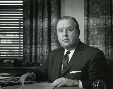 President James Harlow at his desk.