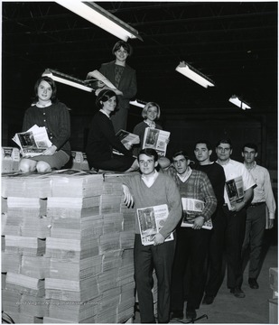 'Members if Kappa Kappa Gamma sorority and 100th Anniversary Office workers mail copies of the Charleston Gazette-Daily Mail's 100th Anniversary supplement, 'Threshold,' to WVU alumni.'