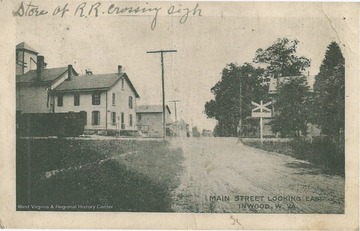 A store is located on the left at the railroad crossing.