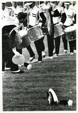 A band member loses hat while they perform.