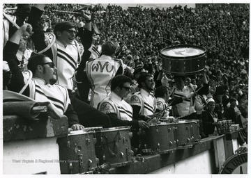 WVU band in stands cheers for the team.