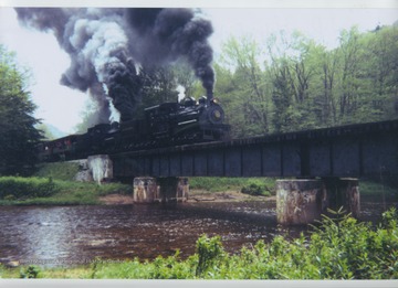 Train crossing a river on the Cass Scenic Railroad in West Virginia.