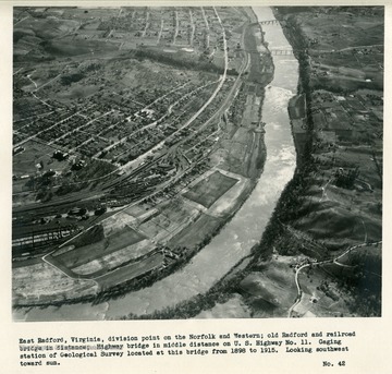 'East Radford, Virginia, division point on the Norfolk and Western; Old Radford and railroad bridge in distance; Highway bridge in middle distance on U.W. Highway No.11.  Gaging station of Geological Survey located at this bridge from 1898 to 1915.  Looking southwest toward sun.'