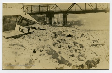 A view of frozen river in Morgantown; a wharf to left.