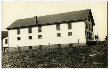 A building next to harvested field.