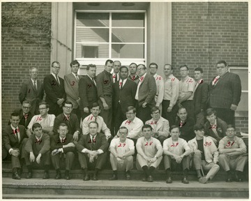 A group portrait of a physics class (?) at WVU. The names correspond to the numbers on the photograph. 1. D.B. Williamson, 2. ? Arnett, 3. David Clase, 4. Doug Dickens, 5. Don Harmon, 6. Harry McKinney, 7. A.P. Arya, 8. Paul Marley, 9. Wilbur Kimbraugh, 10. unknown, 11. James Kelter, 12. Jim Smith, 13. Bill Wallace, 14. Nick Blaskavich, 15. C.D. Thomas, 16. Jackson Auvil, 17. Tom Pauls, 18. Gary Benninger, 19. Mike Palmer, 20. Lynn Walls, 21. Bill Vehse, 22. Roger Buzzard, 23. Carl A. Ratler, 24. Larry Stenger, 25. Larry Headley, 26. Dave Walker, 27. Jim Barb, 28. David Selone, 29. Jim Champion, 30. Lional Craddock, 31. ? Spiker