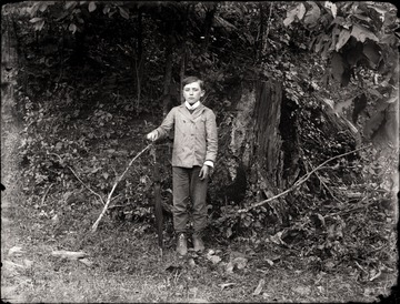 Boy is holding an umbrella.