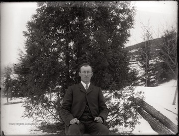 A portrait of man seated in snow covered outdoors, Helvetia, W. Va.