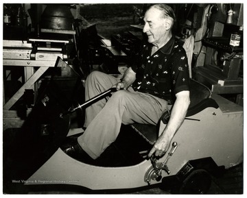 An unidentified man sits in a cart.