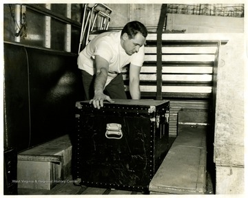 An unidentified male loads a box.