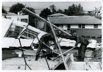 A house destroyed by tornado, near intersection of Smith Street and Pennsylvania Avenue being torn down.