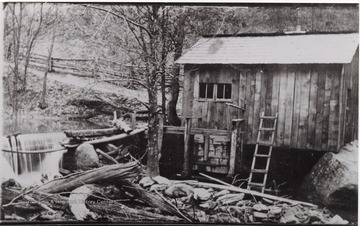 Picture of a wooden building next to the Birch River.