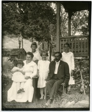 Back to Front: Alma, Lena, Gertrude, Anna Marti Teuscher, Jacob Teuscher, Margaret. Cheese house in the background.