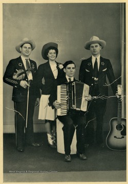 "Brother Cy is at the left next to his is "Chickie", then Marion Martin with his accordion and the sad looking fellow with the guitar is yours truly-- Doc Williams."