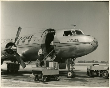 Propeller-powered American Airlines passenger aircraft on airport runway. 