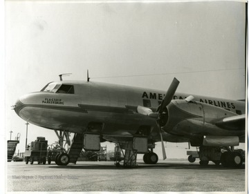 Propeller-powered American Airlines passenger aircraft on airport runway. 