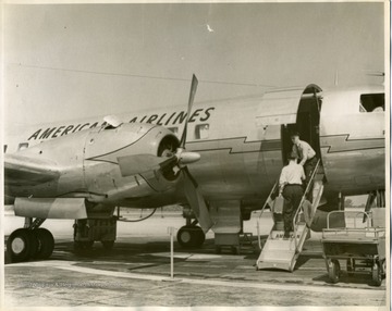 Propeller-powered American Airlines passenger aircraft on airport runway.