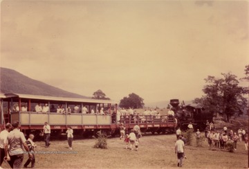 Color photograph of crowded open cars on the Cass Scenic Railroad. Information on the back includes: " Stephen Trail Collection. . . from Buddy Strokes 3/2000"