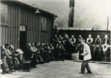 Preacher Eddie Martin delivers a sermon outside the locker room.