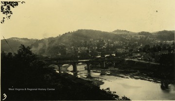 Photograph taken from the west bank of three bridges spanning the river.