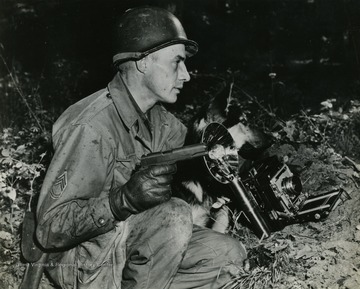 Young was also a combat photographer and attached tothe 361st Engineers Special unit  and at times attached to Third Army commanded by George Patton during the push into Germany. Note the friendly dog sitting next to Young is a German Shephard.