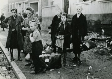 Information on back of photo reads: "German civilians are rounded up for evacuation from Schaffhausen, occupied by Seventh U.S. Army troops March 14, 1945. The German town, six miles north of the frontier of Alsace, is under constant enemy shellfire."