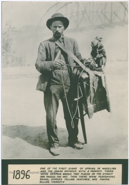 Caption under the photograph reads, "One of the first signs of Spring in Wheeling was the Organ Grinder with a monkey. There were German bands that played on the street and passed the hat. Then there were performing bears, gypsies telling fortunes, and fakirs selling trinkets."