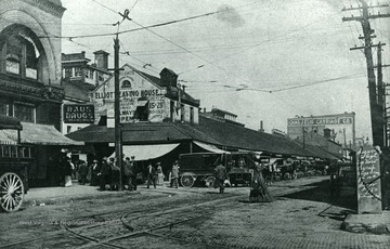 This photograph shows the old Market Auditorium which is now a pedestrian plaza. The building with the Raus Drugs sign is still standing. It's address is 1107 Market Street - the Alfred Egeter Building (ca. 1895) a Neo-Classical Revival/Romanesque stone commercial structure (Franzheim, Giesey &amp; Faris, Architechts).