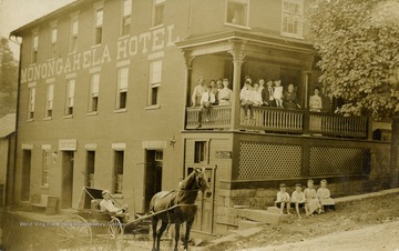 People pose for picture on front porch of the Monongahela Hotel. (From postcard collection legacy system.)