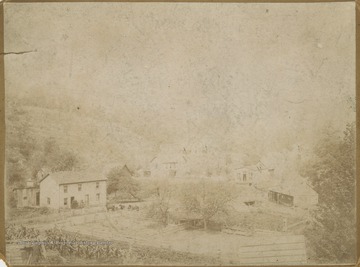 Scene of houses bordering small plots of farm land located in Monongalia County. 