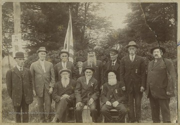 Photograph taken around the turn of the century. The man on the far right is identified as Daniel Sillinger. The others remain unidentified. Back of the photo reads, "One seems to hear the rattle of the rifles once again as in the days, Gods Daisies, were redeemed by the rain. The clamor of the Captiains, the 'Charge!' and the 'Retreat!', and think of love that listens for unreturning feet."