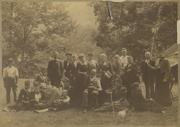 Group portrait taken in the woods running along the river. See original for photo roster.