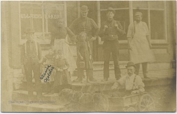 Group poses before the store from. Only the little girl on the left, "Vernie Nolder" is identified.