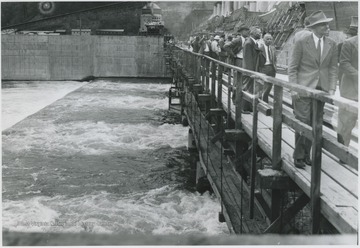 Unidentified men walk along the construction site.