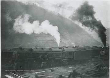 Trains occupy the tracks of the yards.