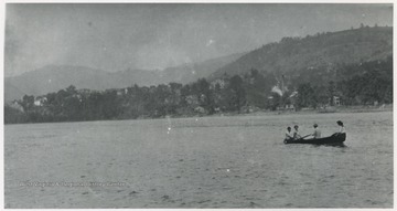 People row across the river below Coney Island and toward Avis. Subjects unidentified. 