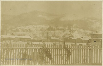 Snow-covered mountains tower over the town.