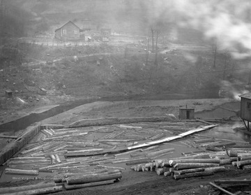 Pond jockey would walk out on ramp as seen in middle of pond and push logs, using a long pike, towards the sawmill.