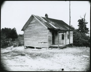 Photo looking at the building's exterior from the dirt path.