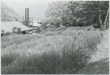 Looking down at the buildings from a hill. New River seen in the background. 