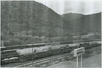 Railroad cars cover the tracks. New River seen in the background. 