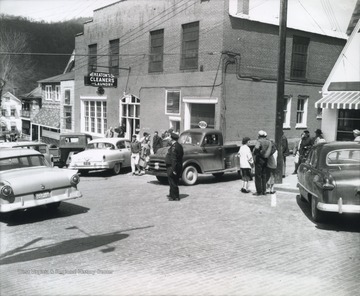 People walk past the building located on 2nd Avenue. Subjects unidentified. 