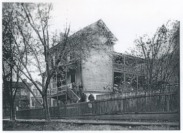 Members of the family pictures on the porch and steps of the house. 