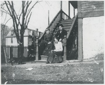 Murrell is pictured on the lower step of her porch located on the corner of 5th Avenue and Summers Street. Her associates are unidentified. 