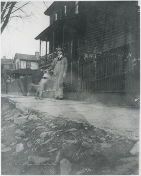 Murrell pictured outside the fence that surrounds his house with his dog. The home is located on the corner of 5th Avenue and Summers Street. 