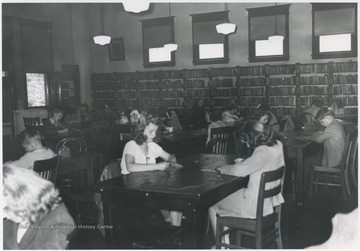 Students taking the Golden Horseshoe Exam inside the building. Subjects unidentified. 