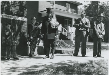 Parker, center, prepared for the re-enactment of the Methodist preacher circuit rider next to the church located on Third Avenue. Other subjects unidentified. 