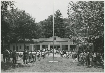 Campers line up in front of the main building. Subjects unidentified. 