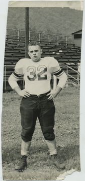 Gwinn, a tackle for Hinton High School, is pictured on a field in front of the bleachers. From Hinton Daily News Collection.